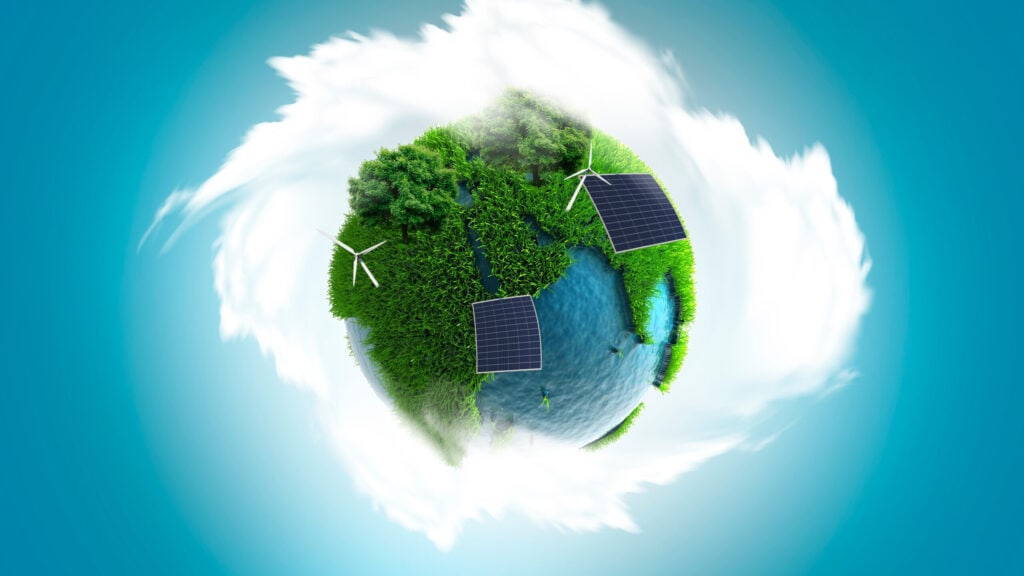A globe with green land, forests, and water features solar panels and wind turbines, surrounded by clouds and a blue sky background.