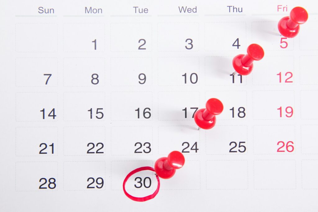 Calendar page with push pins marking days on Tuesdays and Fridays, covering the 5th, 9th, 12th, 16th, 19th, 23rd, and 30th. The 30th is also circled in red.